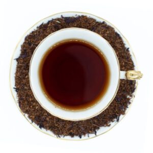 Velvet Earl Rooibos Herbal Tea in a white and gold vintage teacup and saucer